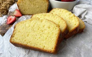 Horizontal image of slices of a homemade baked yellow cake on parchment paper.