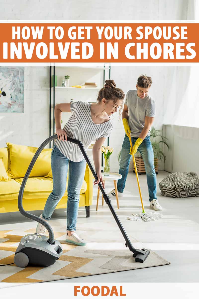 Vertical image of a couple cleaning the floor together.