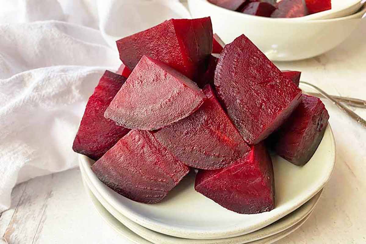 Horizontal image of a plateful of cubed roasted beets.