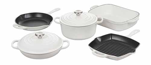 Image of the Le Creuset 7-Piece collection of cast iron enameled cookware in a white color.