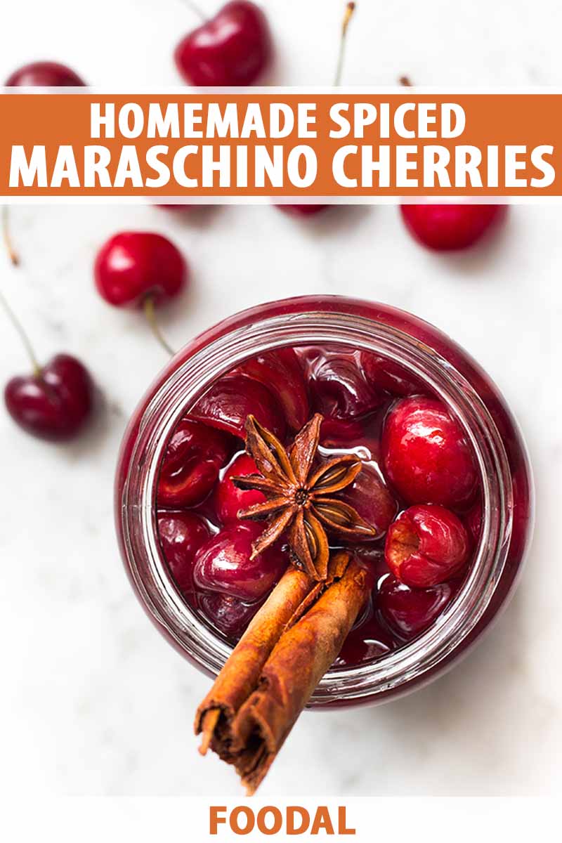 Vertical top-down image of a jar full of maraschino cherries topped with whole spices, with text on the top and bottom of the image.