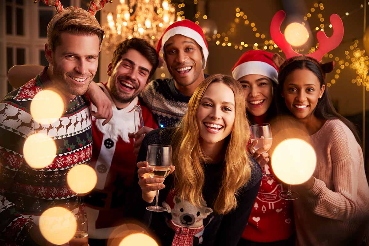 Horizontal image of friends celebrating together in festive rompers.
