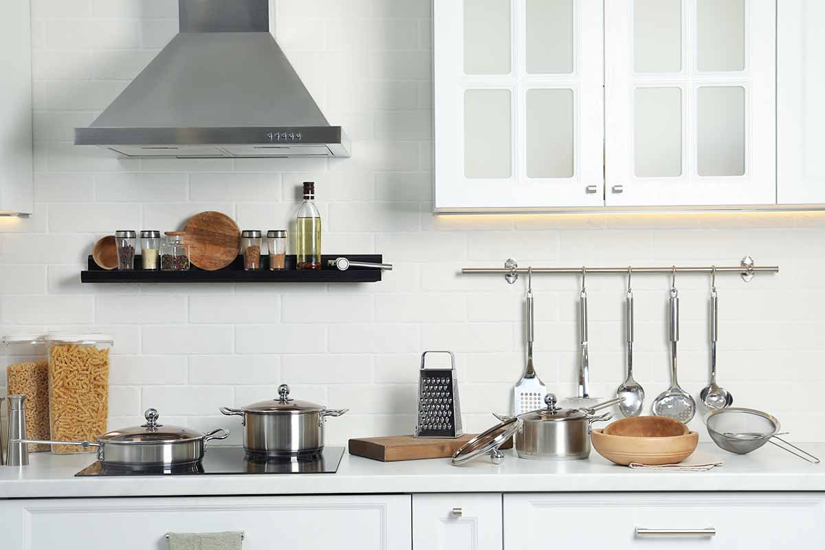 Horizontal image of a countertop with different cooking utensils.