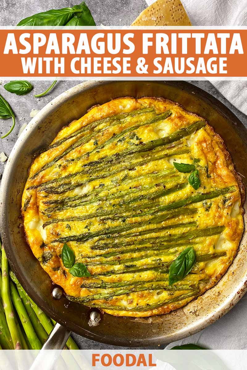 Vertical top-down image of a frittata dish in a pan topped with asparagus spears and basil leaves, with text on the top and bottom of the image.