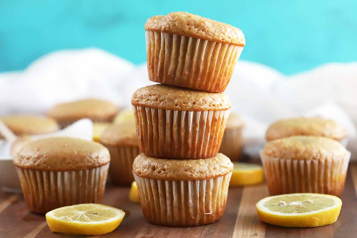 Horizontal image of a stack of muffins with lemons.