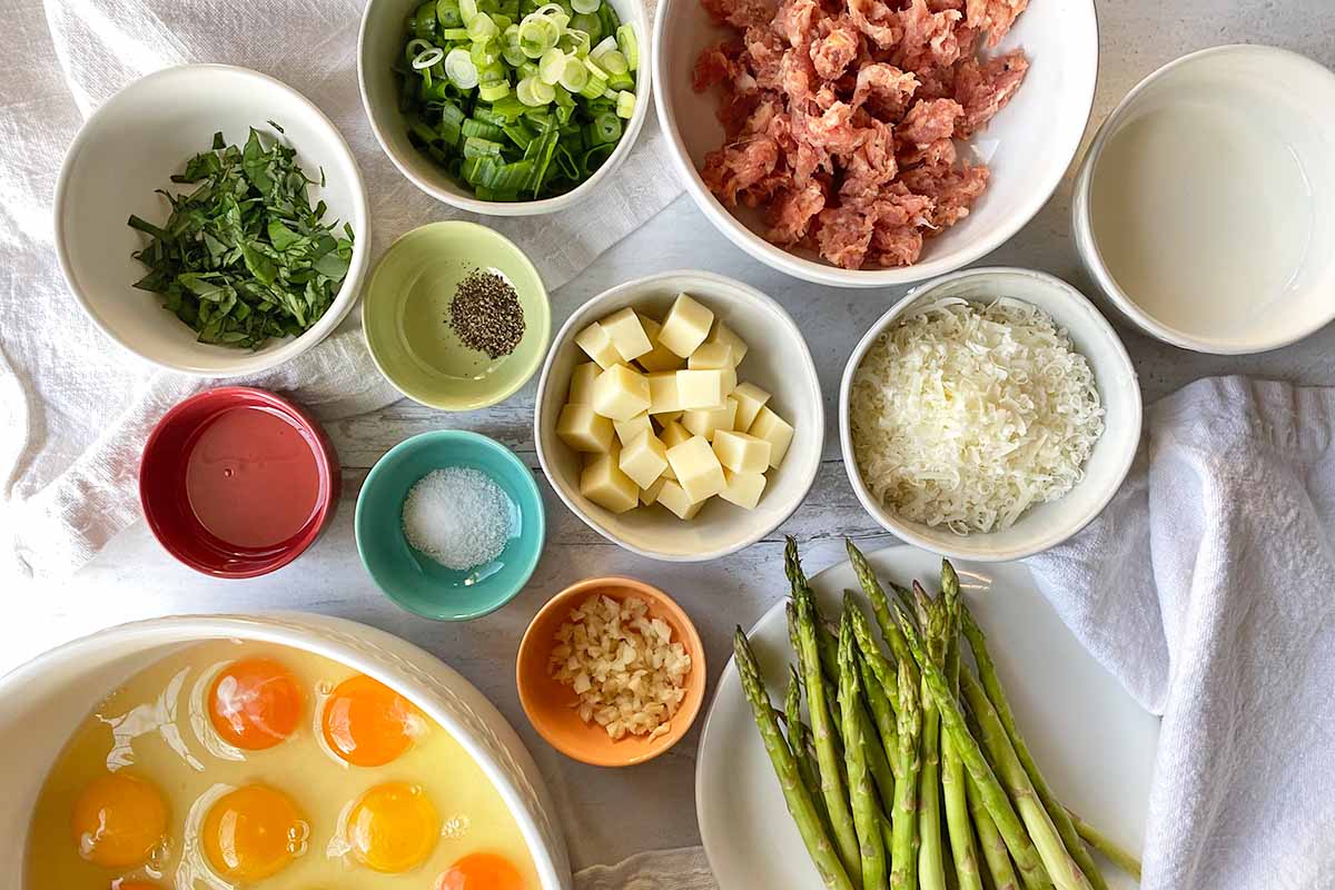 Horizontal image of assorted ingredients prepped and measured in different bowls.