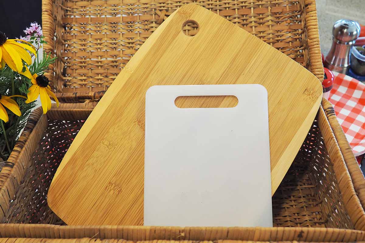 Horizontal image of two cutting boards inside a basket.