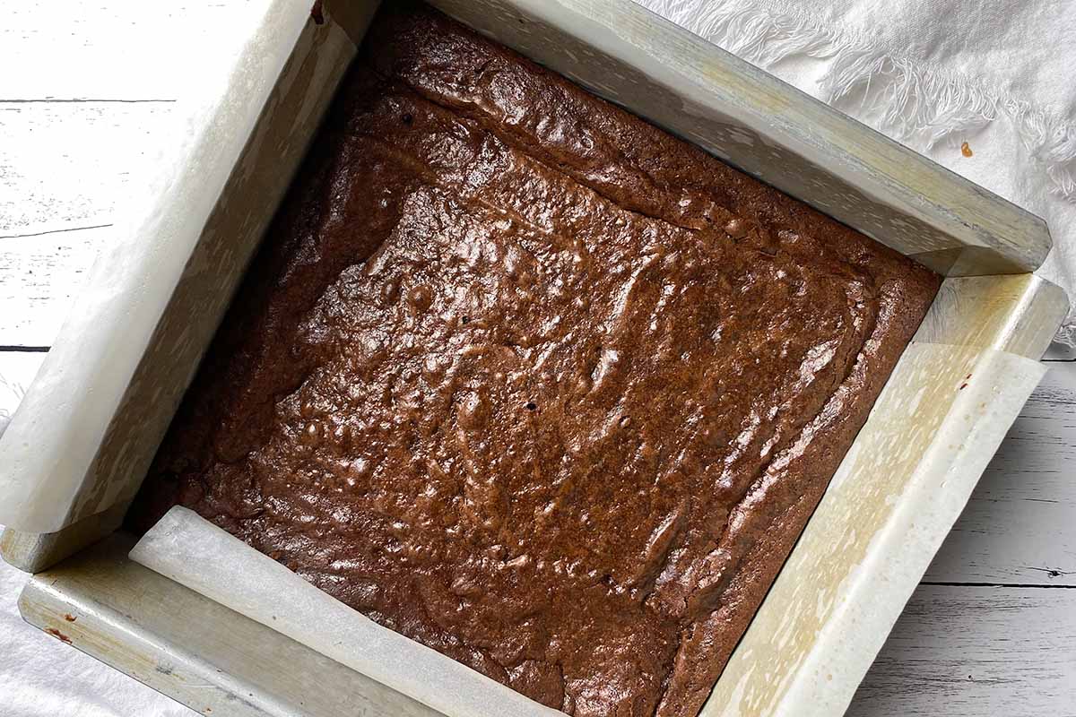 Horizontal image of a square pan with freshly baked brownies.